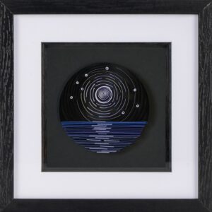 A paper quilled sky with a moon above the sea.